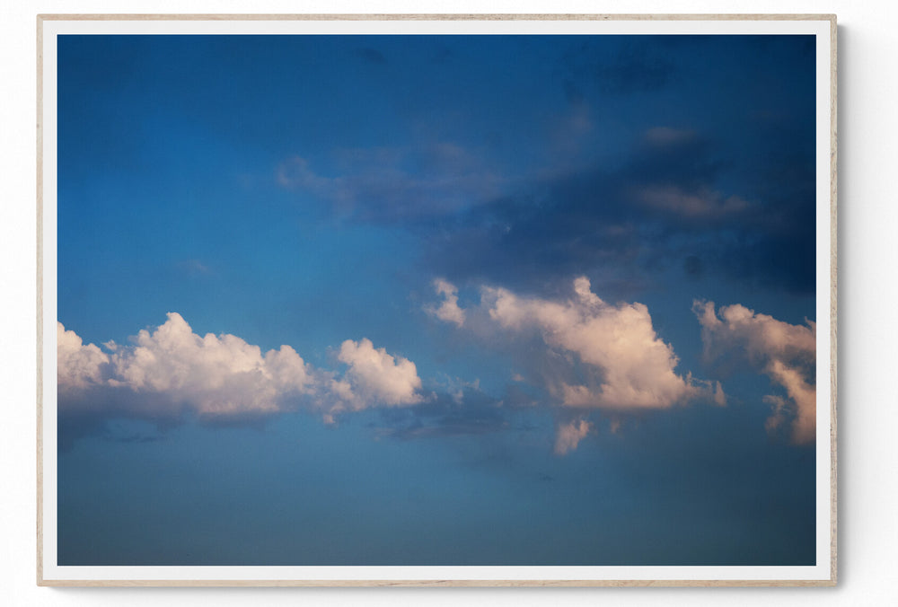 Minimalist photograph of cumulus clouds against a blue Athens sky