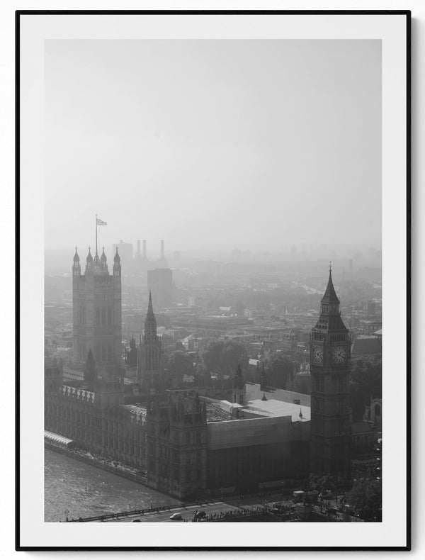 Aerial black and white photograph of London in fog, Big Ben and Westminster Bridge visible through cloud